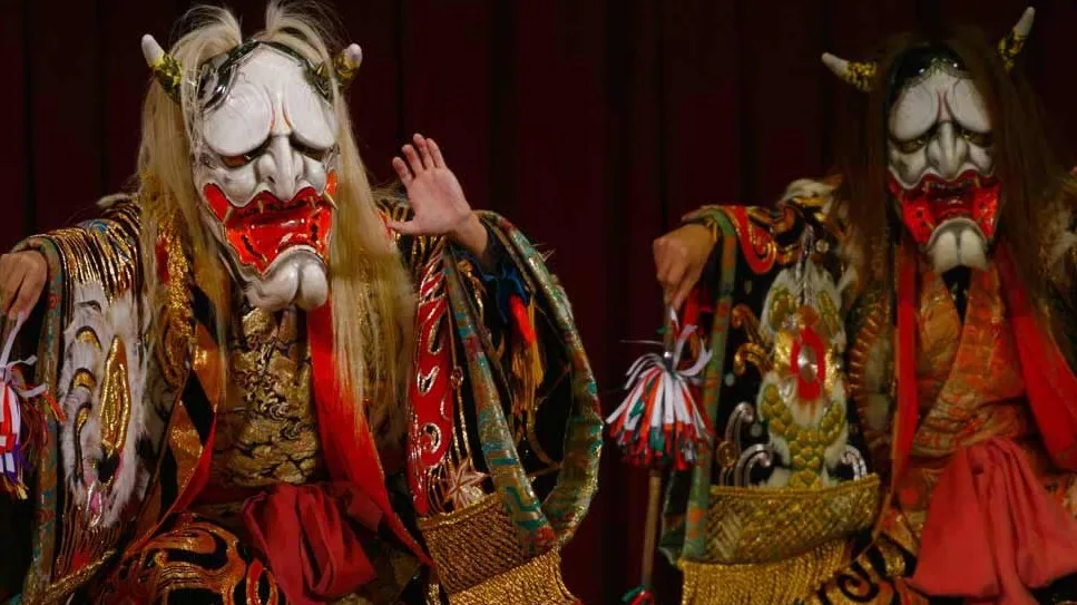 two men are wearing a white colored demon kagura mask no, with teeth. The oni mask has horns. Both characters are wearing traditional Japanese kimono